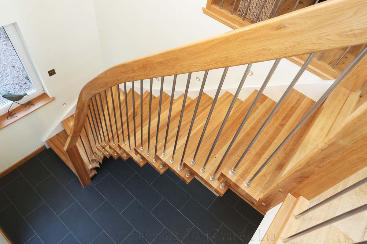 Bespoke Timber Staircase - Aberdeen looking down a floating style oak staircase with black floor below