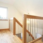 landing balustrade with oak floor and stainless steel spindles around stairwell