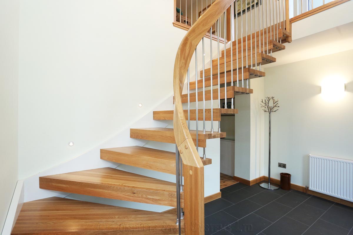 Bespoke Timber Staircase - Aberdeen curving oak stair with black floor below