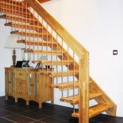 sideboard below a straight flight floating style staircase