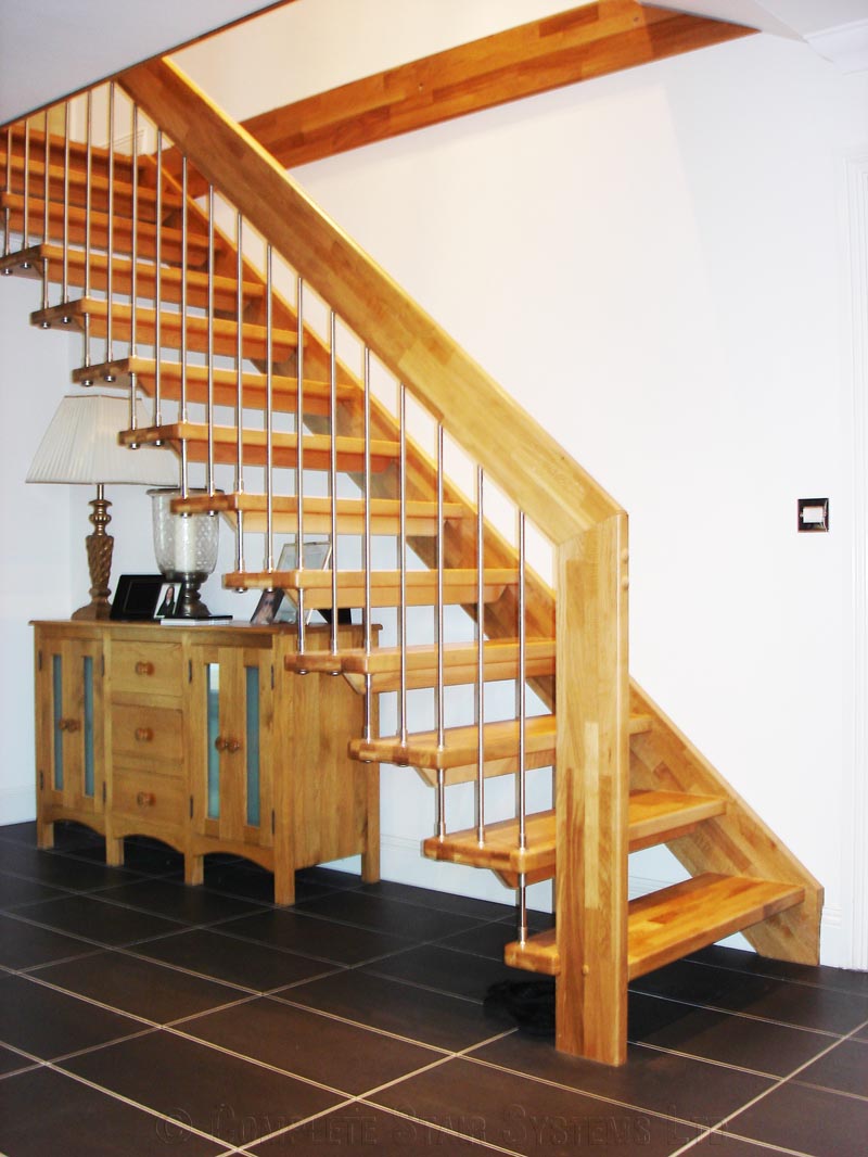 sideboard below a straight flight floating style staircase