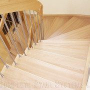 light wood steps on a stair with stainless spindles