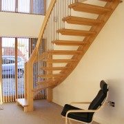 flooring style oak staircase with black chair below