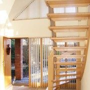 front door and window in house with carpeted floor with floating staircase