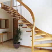 curved oak handrail and stainless steel spindles on a floating staircase