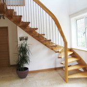 quarter turn stair in hallway with window to side and green plant below