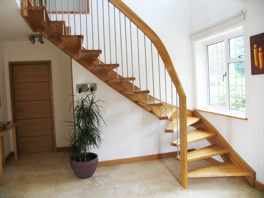 quarter turn stair in hallway with window to side and green plant below