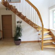 tiled floor in a hallway with quarter turn oak staircase