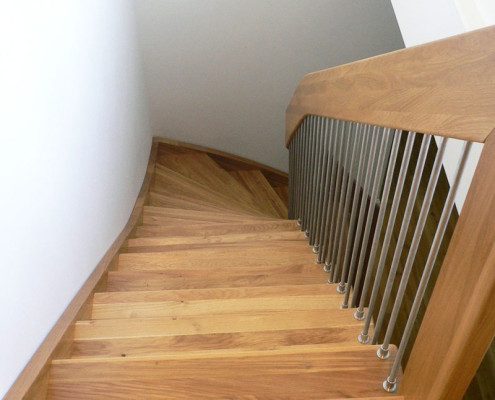 looking down a timber staircase with stainless spindles