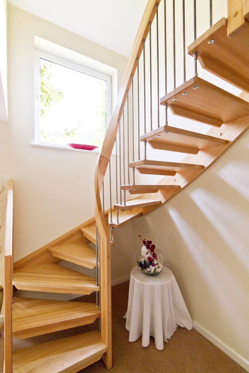 Bespoke Timber Staircase Tadley curving wooden staircase with open risers with small table underneath