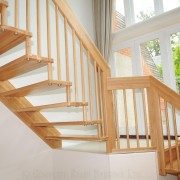 open timber staircase with open risers and large widow behind