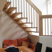 dining room table with floating timber stair beyond