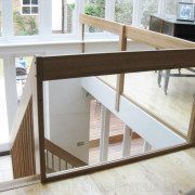 large glass panel on mezzanine floor with grand piano