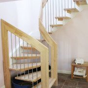 floating style open staircase with dog bed below