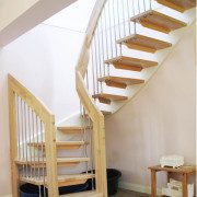 open wooden staircase with stainless steel spindles