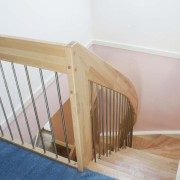 top of a stairwell with blue carpet at top of a light beech staircase