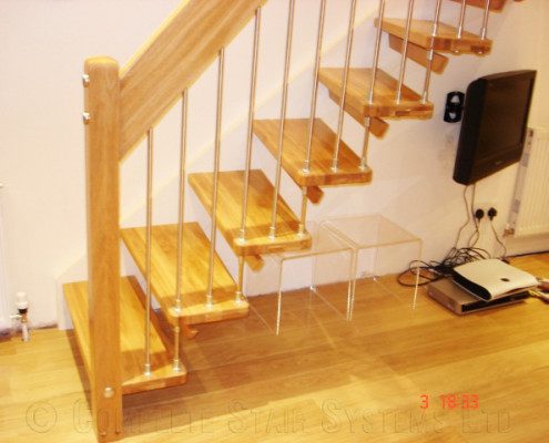 straight open staircase with oak floor below