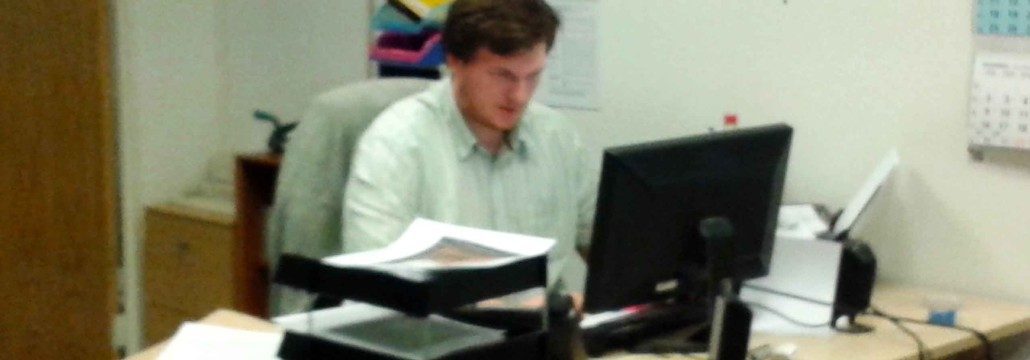 man sitting at desk in office
