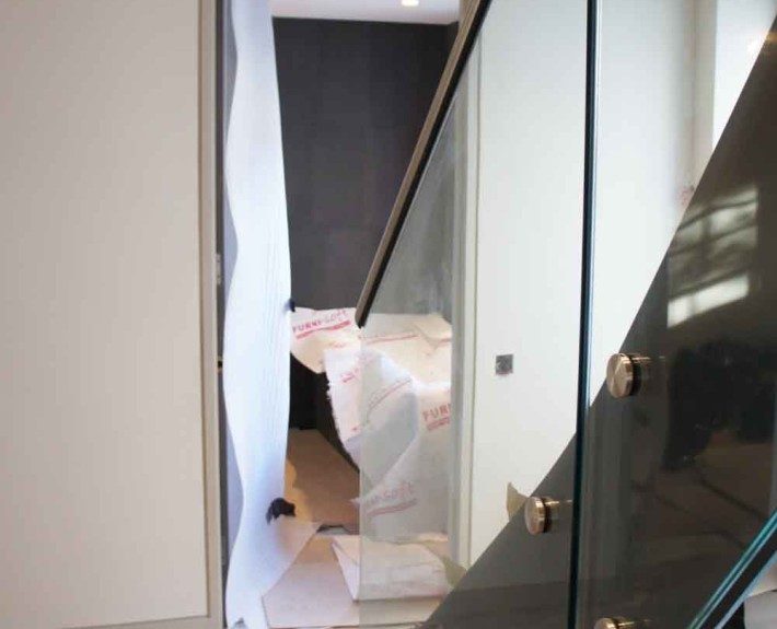 new black steel staircase on a building site with glass panels