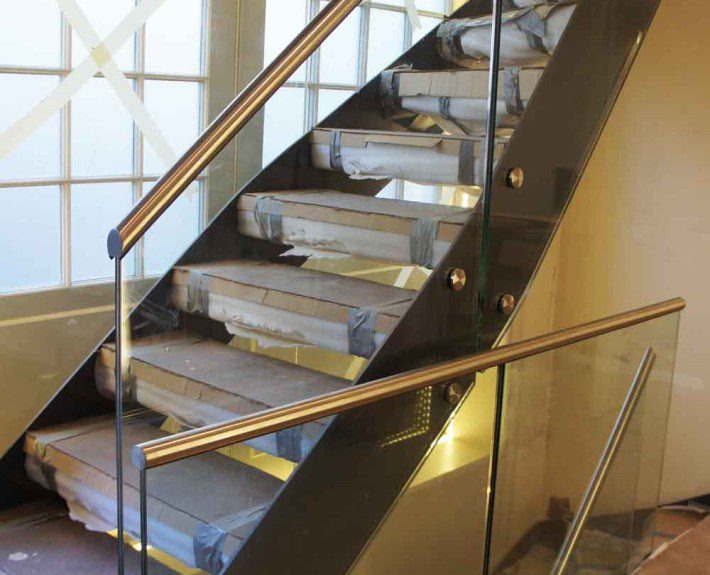 new staircase with glass panels on a building site
