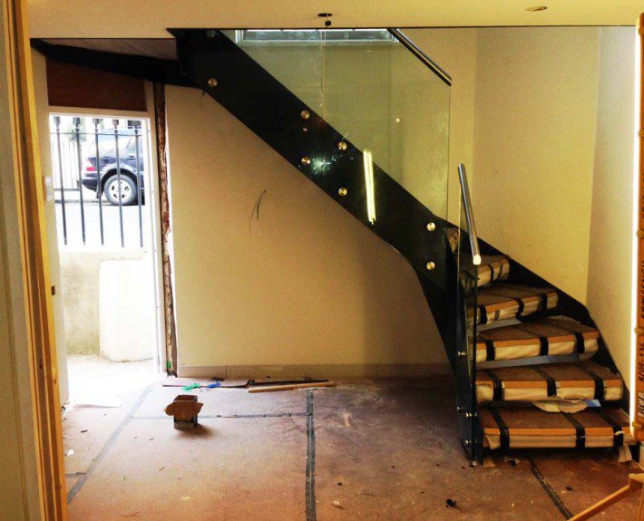 building site with new black steel and glass staircase