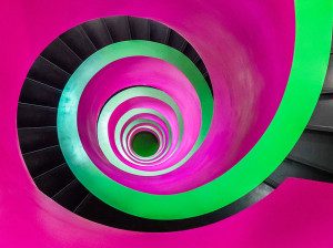 multi coloured pink and green helical stair spiraling down