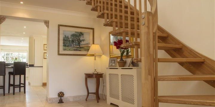 oak floating stair in a hallway with tiled floor
