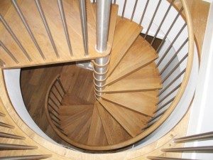 oak tread spiral stair with stainless spindles in a circular opening