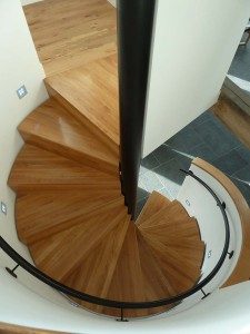 looking down on a oak tread spiral staircase with a black centre column