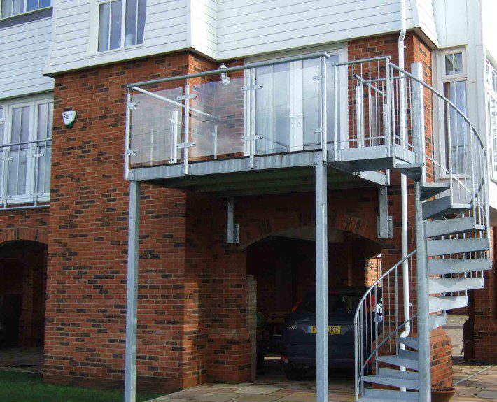 outdoor spiral stair with balcony with glass panels
