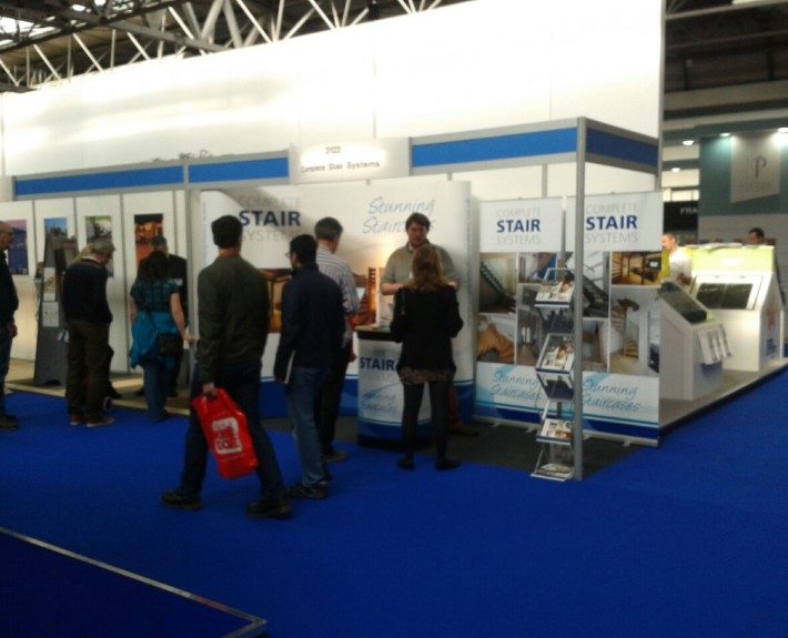exhibition stand with blue carpet with people