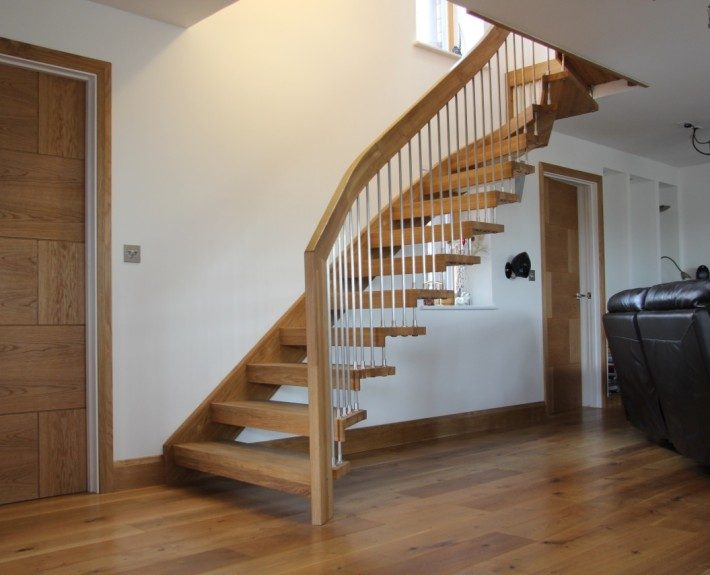 brown leather sofa with a floating timber staircase