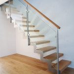 zig zag stainless steel stringer on an open stair with glass panels
