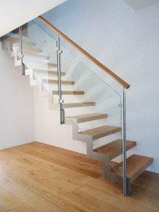 zig zag stainless steel stringer on an open stair with glass panels