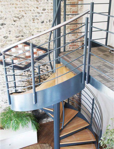 Commercial Spiral Staircase - Wickham, Hampshire 3 stone wall behind a steel and oak spiral staircase