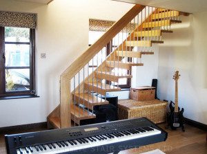 Timber Staircase - Surrey keyboard in front of a timber floating staircase