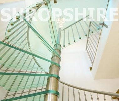 glass step spiral staircase with a stainless centre column