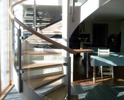 curved glass panels on a spiral staircase in a house