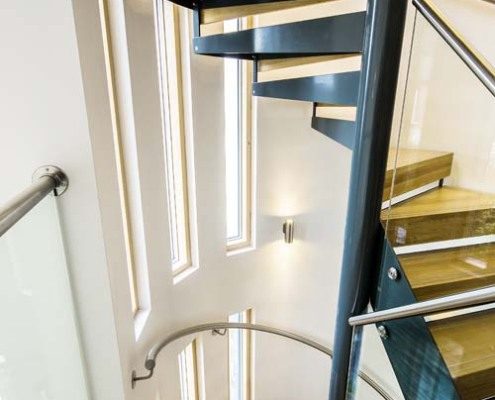 double flight spiral staircase with black steel and oak steps