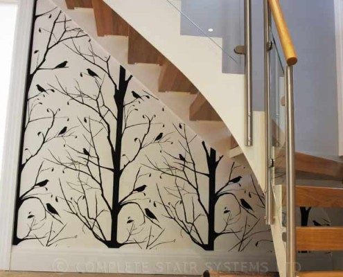 hallway with tree design on wall with white steel staircase
