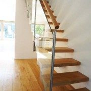 floating style glass and steel staircase on a wooden floor