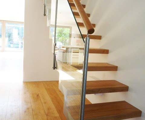 floating style glass and steel staircase on a wooden floor