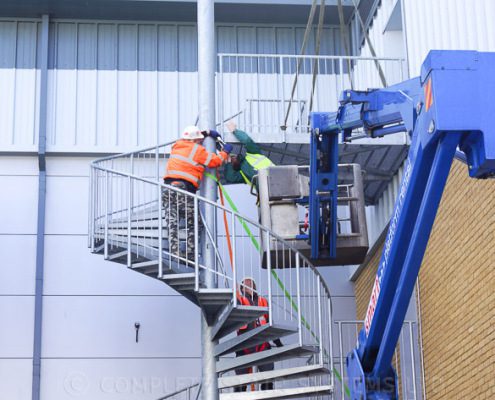 crane installing an external spiral staircase