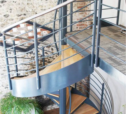 dark blue spiral stair with external stringer and stainless handrail