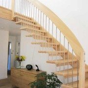 light wood floating style staircase above a green plant