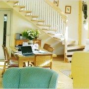 living space with dining table and selection of chairs with floating stair within open risers