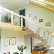landing balustrade with glass panels with floating timber staircase