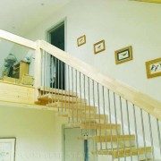 floating style timber staircase with open risers and stainless spindles