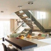 kitchen with steel staircase beyond with glass balustrade