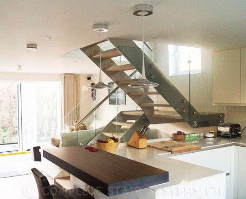Modern-Staircase-London-2 kitchen with steel staircase beyond with glass balustrade